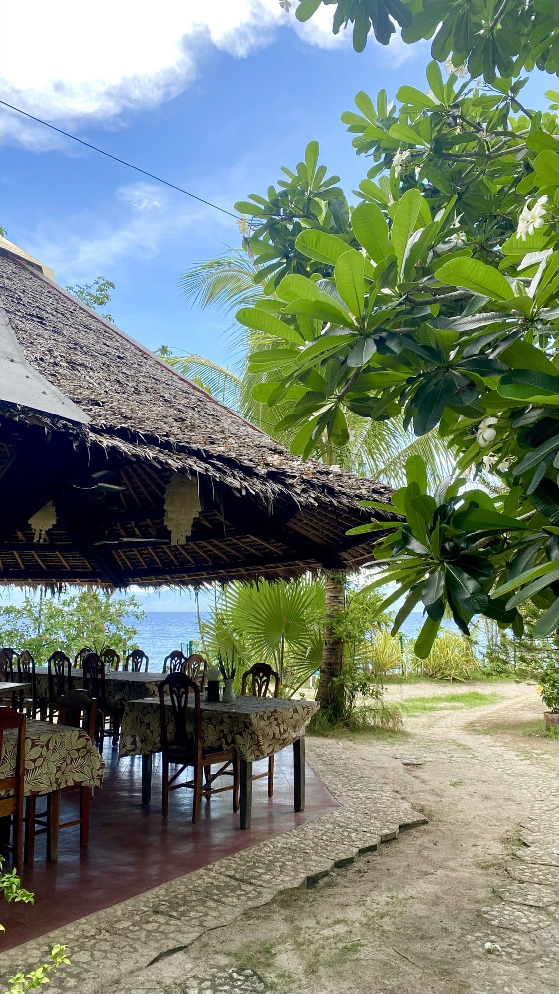 The open-air restaurant and sand path through the grounds
