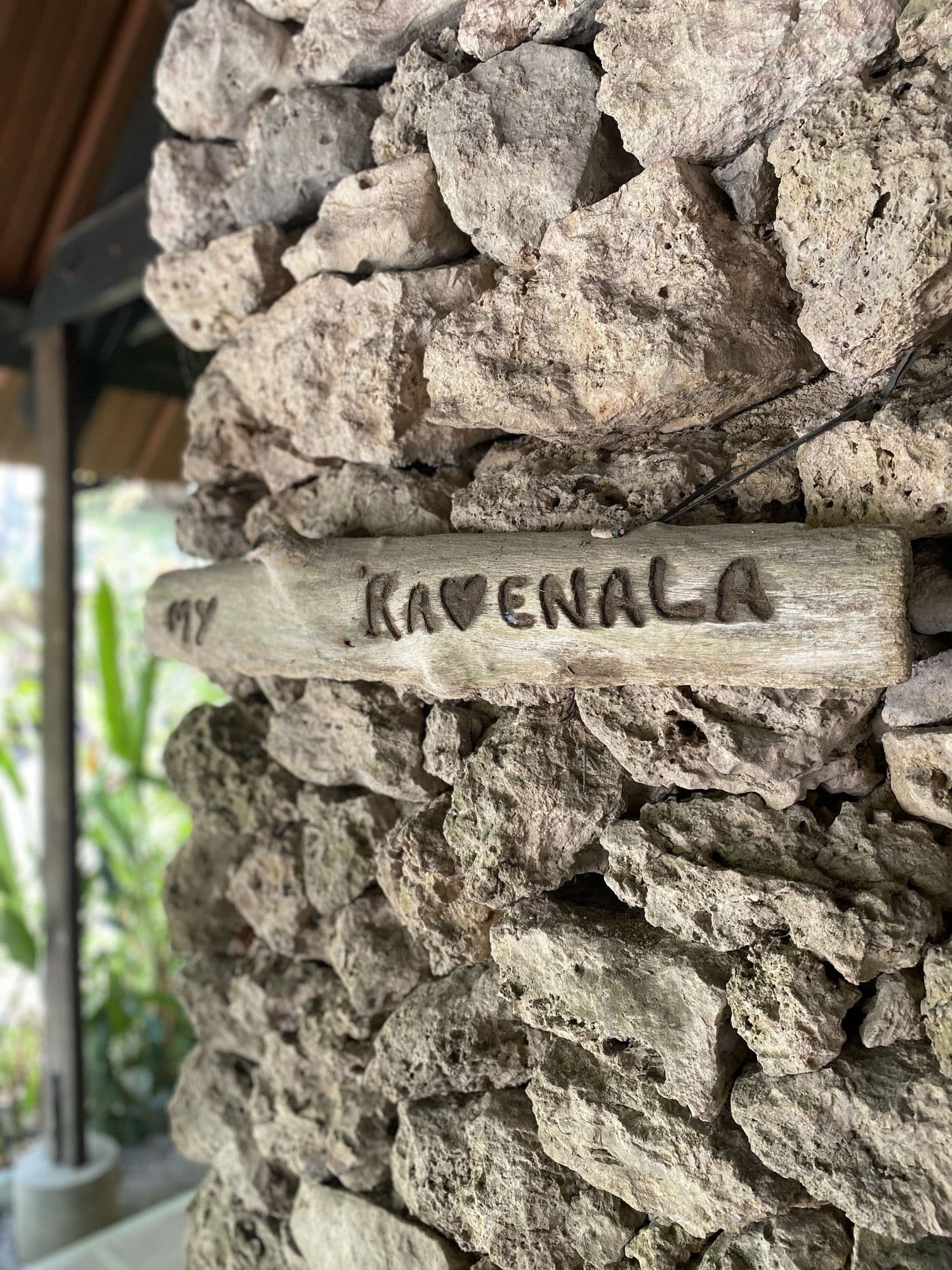 The hand-carved Ravenala sign on a coral stone wall