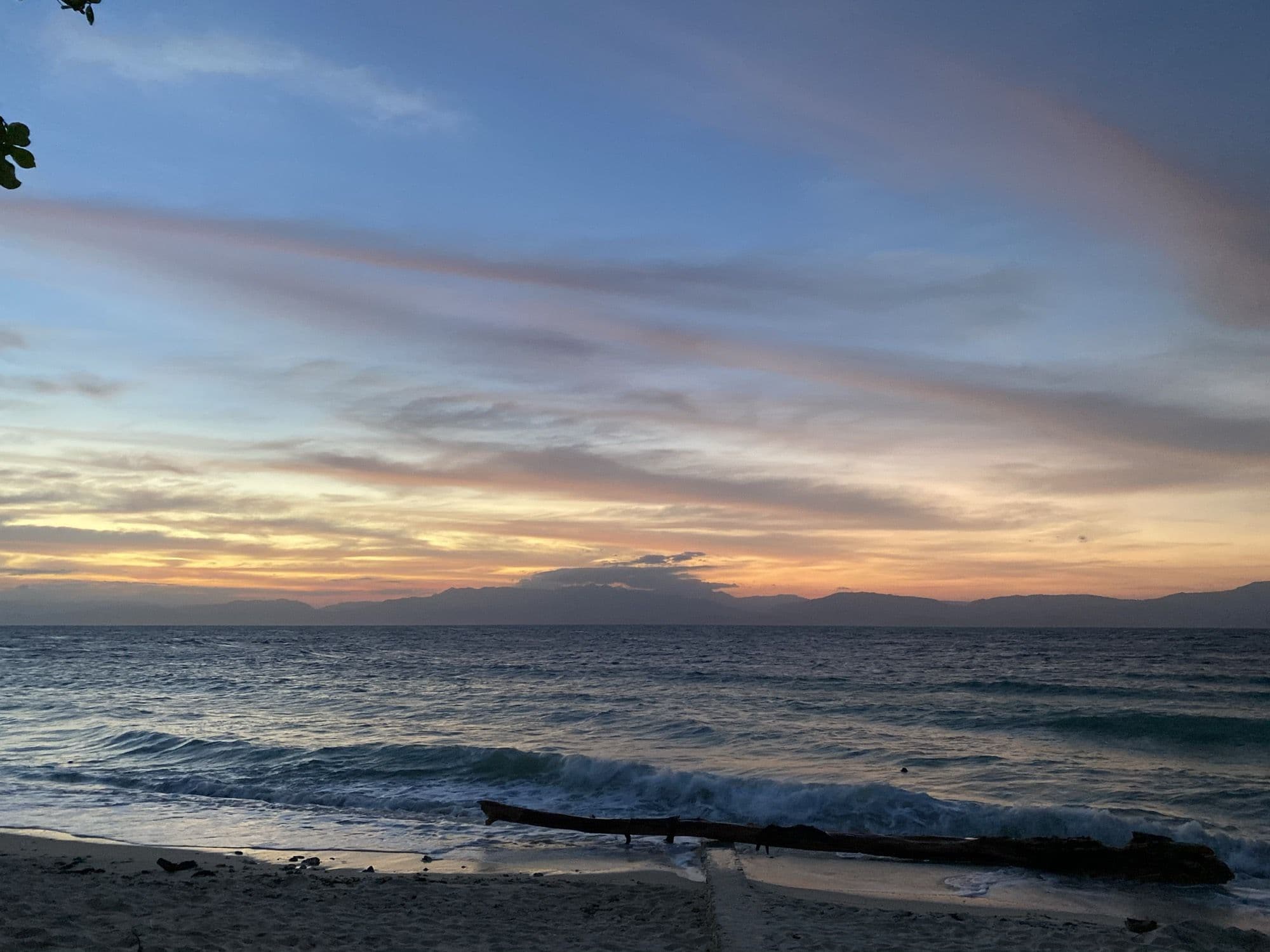 Sunset over the sea with Negros Island on the horizon