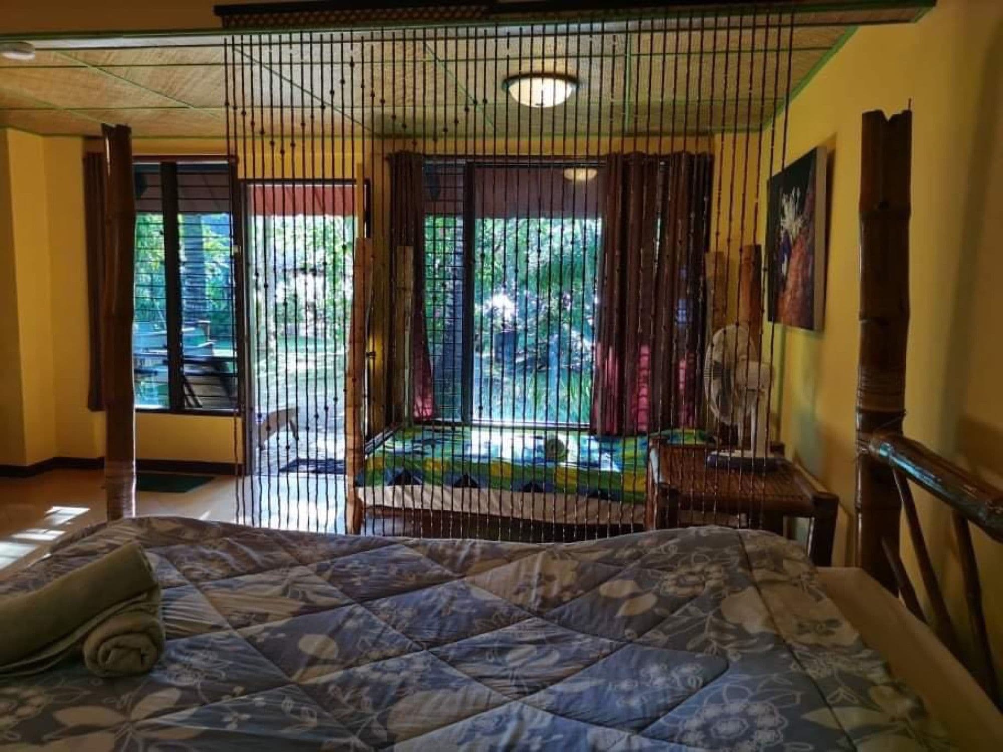 Family room with four-poster bed and garden-facing windows